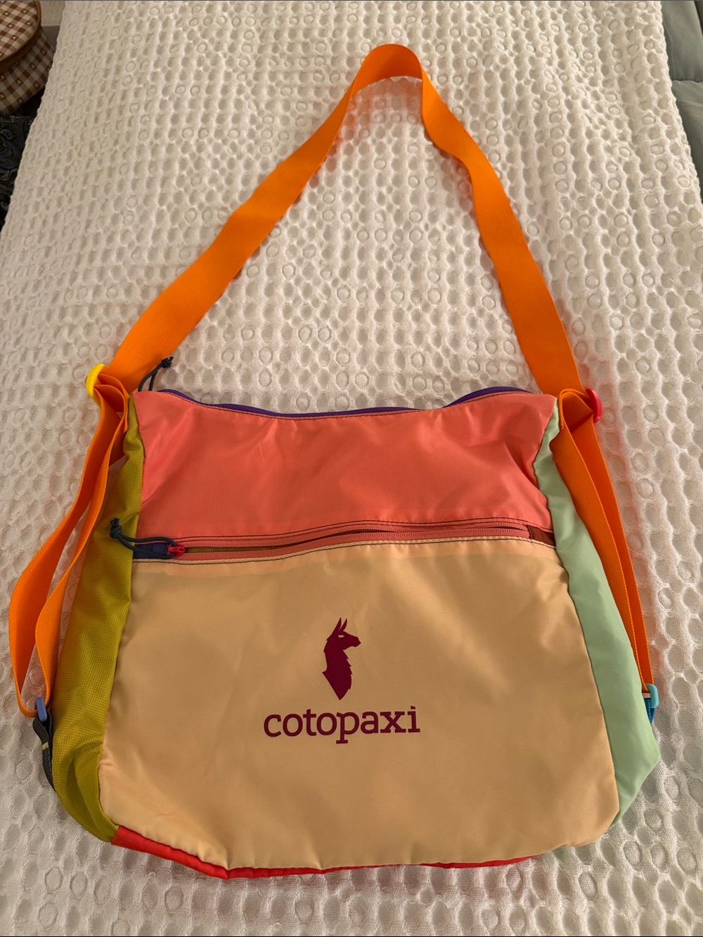 cotopaxi multicolor crossbody bag with orange strap